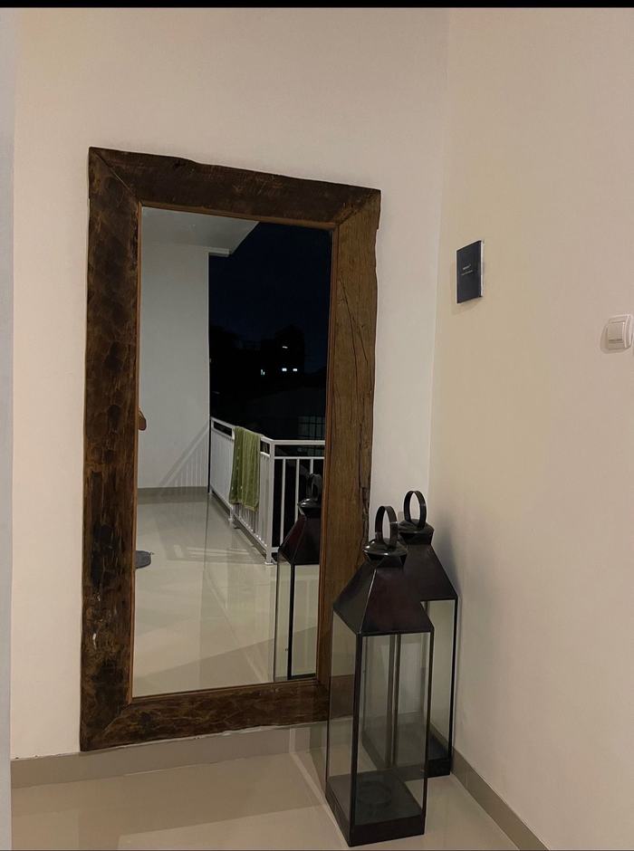 Entry landing with oversized reclaimed-wood mirror and lanterns